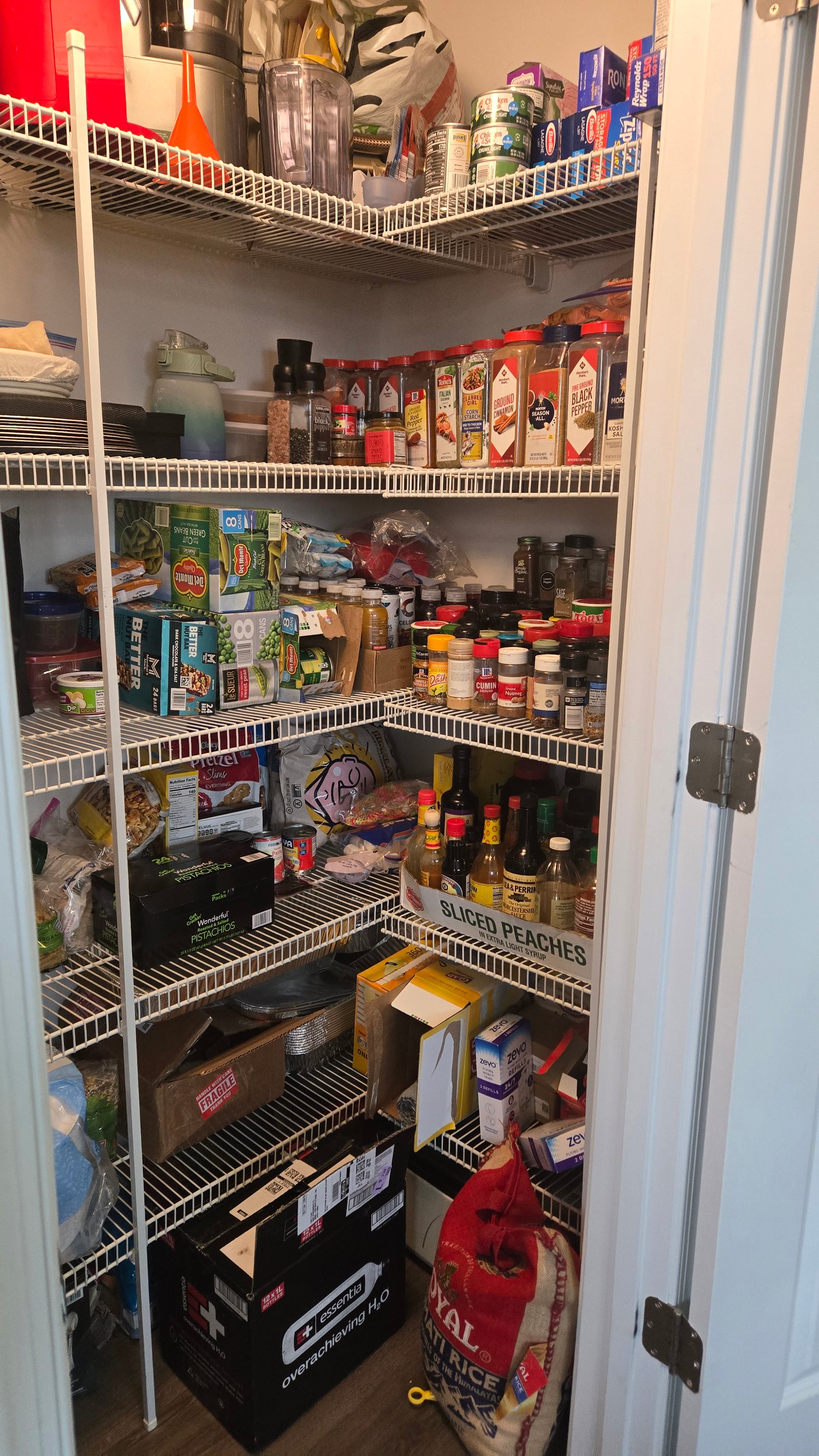 Pantry before — packed shelves, no system
